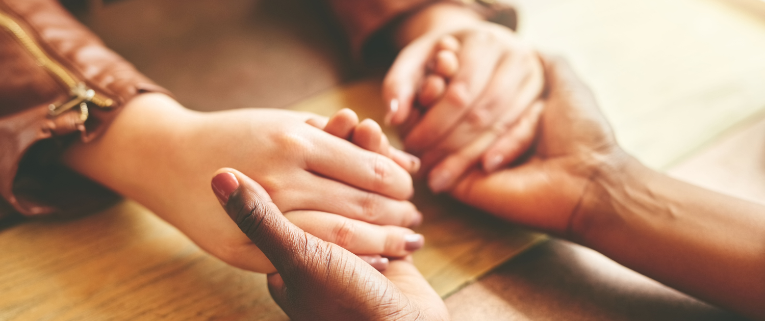 Volunteers One person's hands holding the hands of another